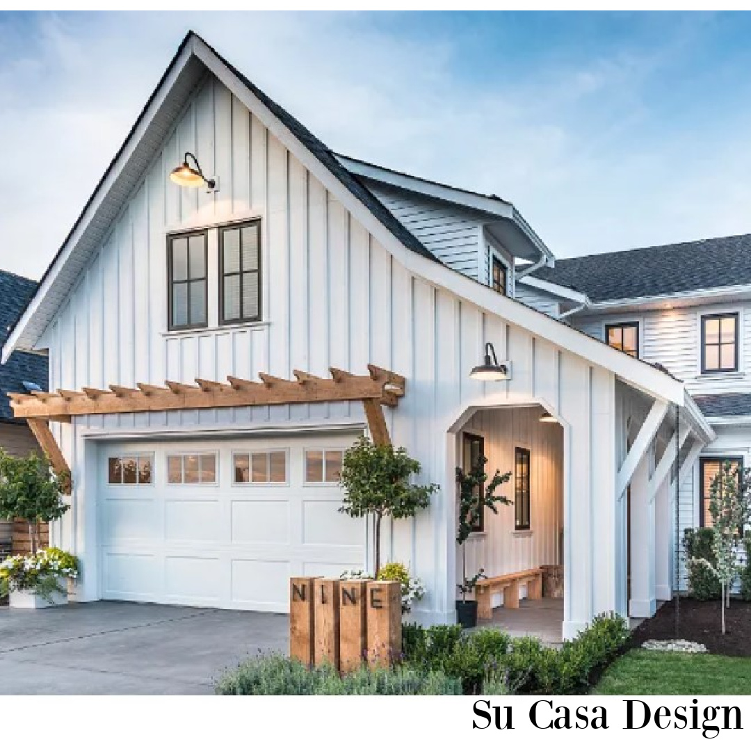 Beautiful modern farmhouse exterior with board and batten  painted Chantilly Lace (a Benjamin Moore white). #whitehouseexteriors #whitepaintcolors #whiteexteriors