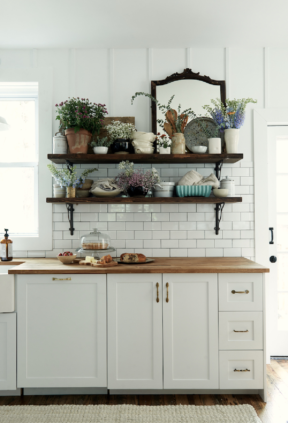 Open shelves in a modern rustic kitchen with subway tile by Leanne Ford. #modernfarmhousekitchen