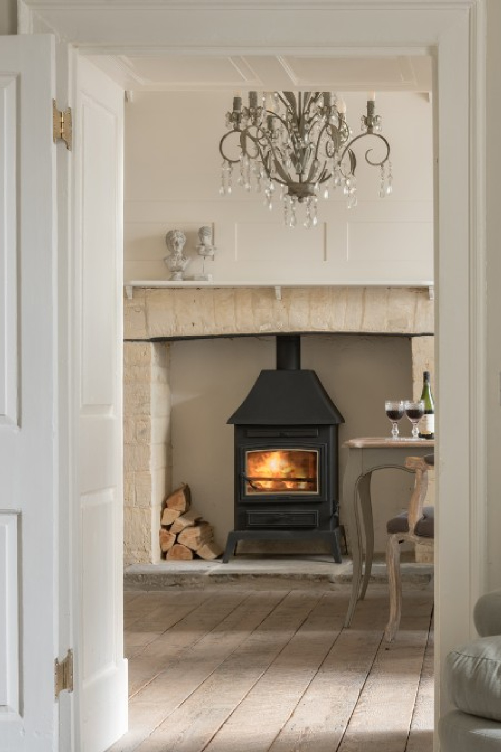 Woodburning stove in limestone fireplace - Flower Press holiday rental Biburg Cotswolds. #cotswoldscottage #englishcountry #cottageinteriors