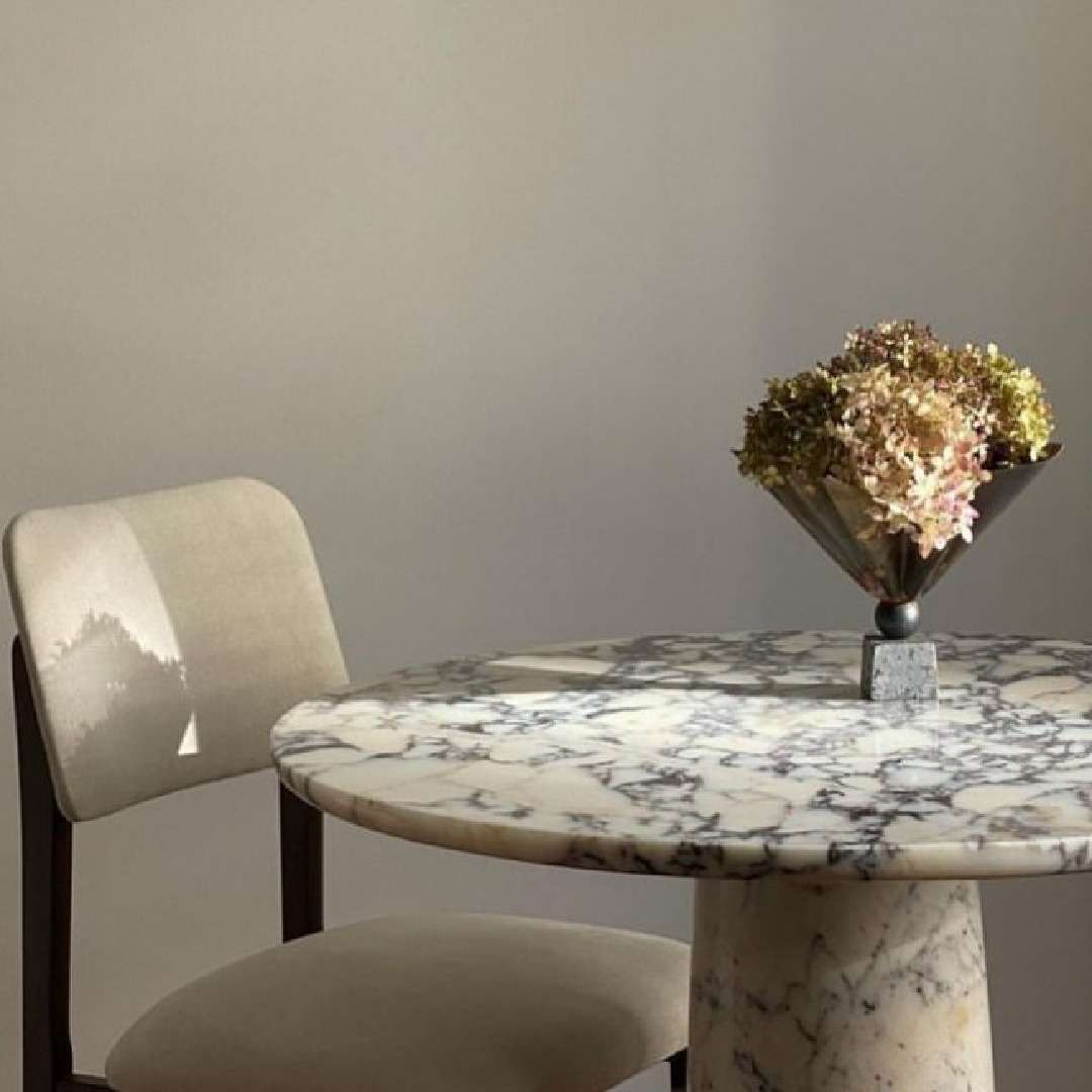 Serene modern minimal vibes in a dining area with marble table and dried hydrangea - @rebeccagoddard.