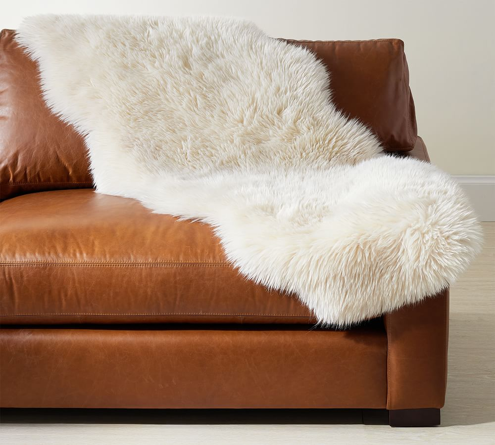 Faux Sheepskin on leather sofa, Pottery Barn