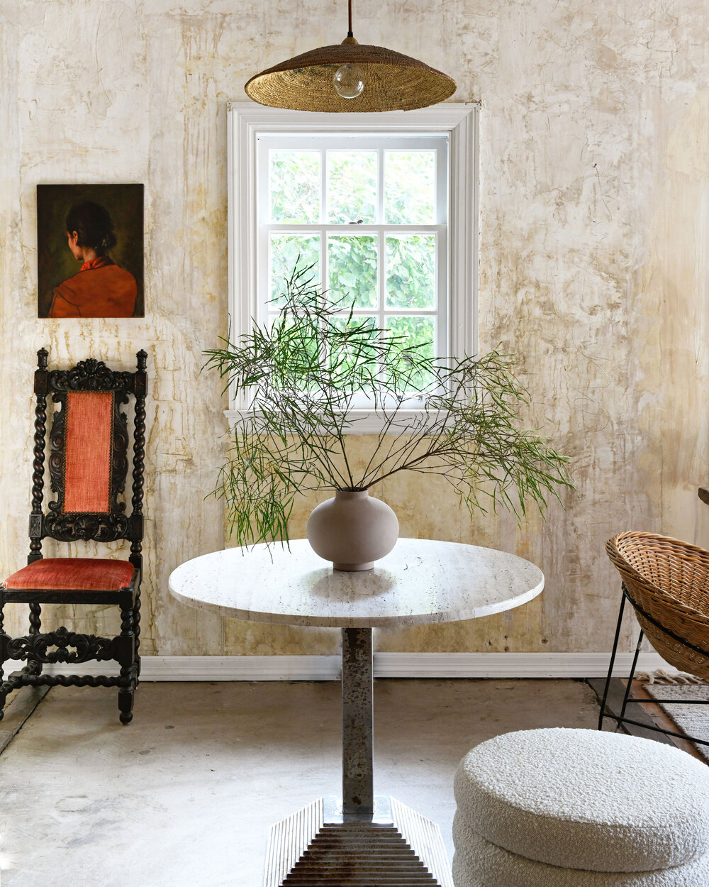 Leanne Ford designed rustic modern cottage with round marble top bistro table and boucle ottoman - photo by Erin Kelly.