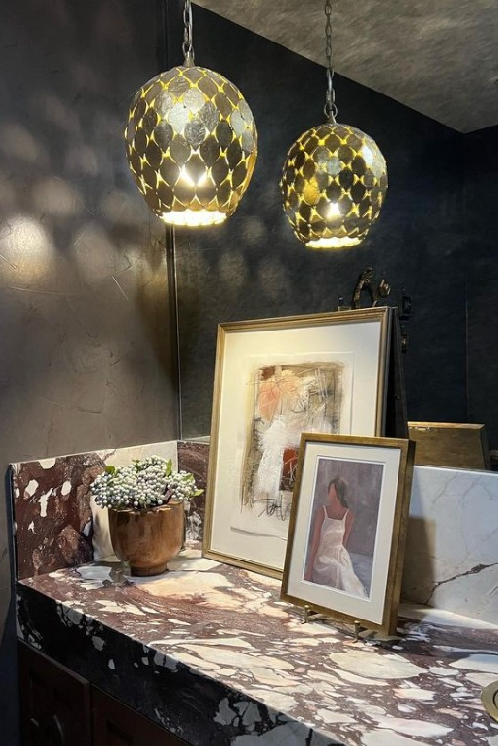 Phillip Jeffries dark wallpaper in a luxuriously moody marble bathroom designed by Sherry Hart.