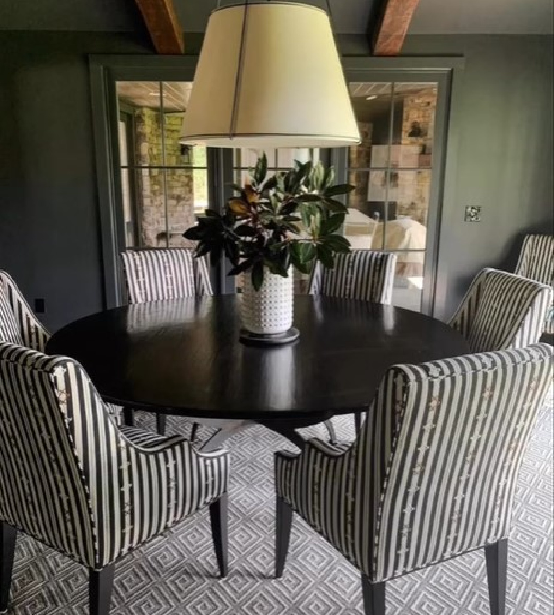 Moody green painted dining room with design by Sherry Hart.