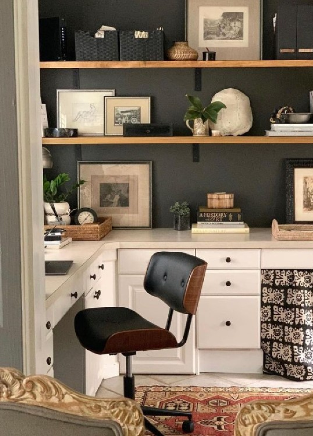 SW Urbane Bronze on walls of a home office with floating shelves and MCM desk chair - design by Sherry Hart.