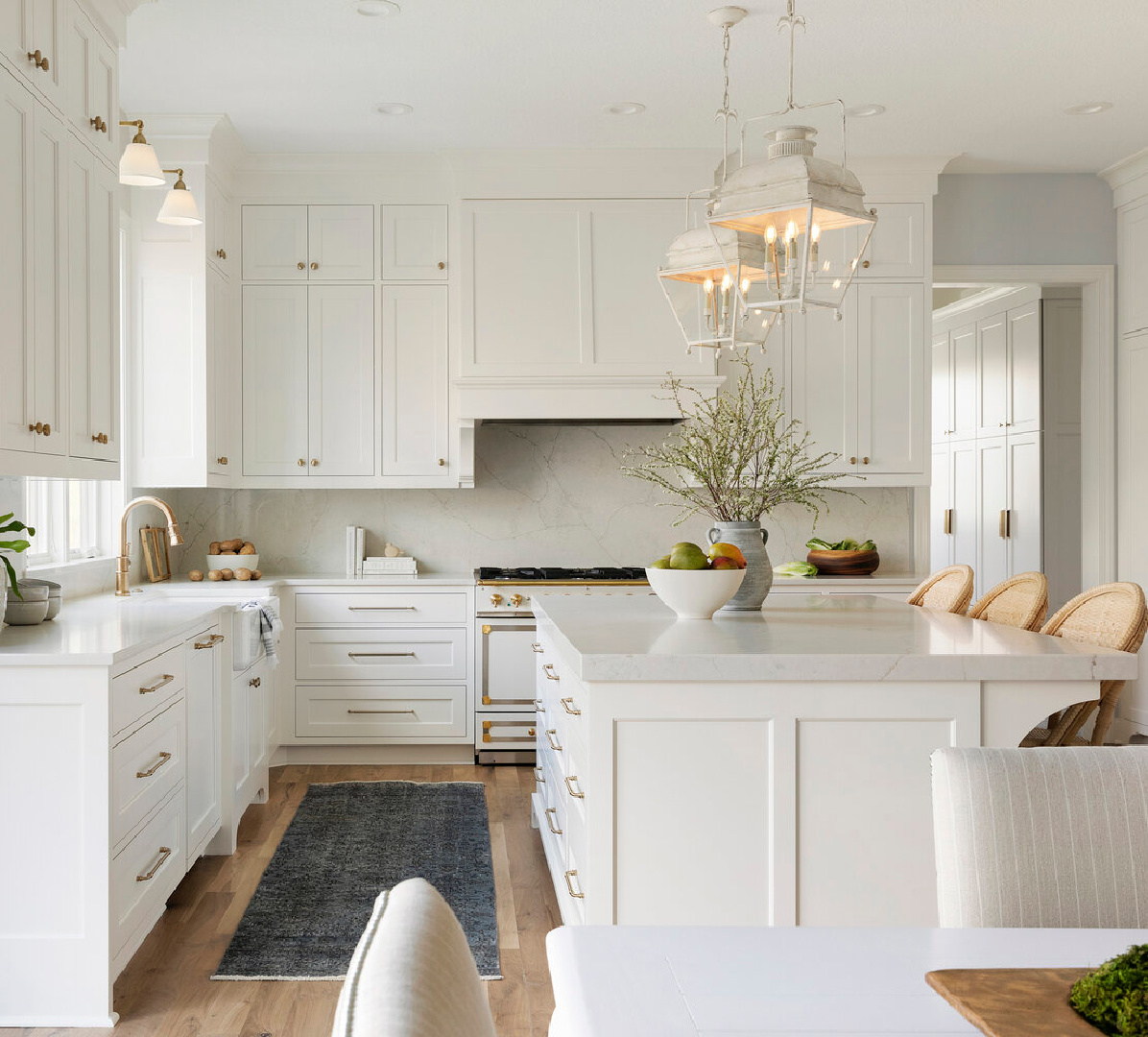 SW Alabaster on kitchen cabinets in a gorgeous timeless kitchen with Holborn lanterns over island - Thompson Construction. #swalabaster #sherwinwilliamsalabaster #kitchencabinets