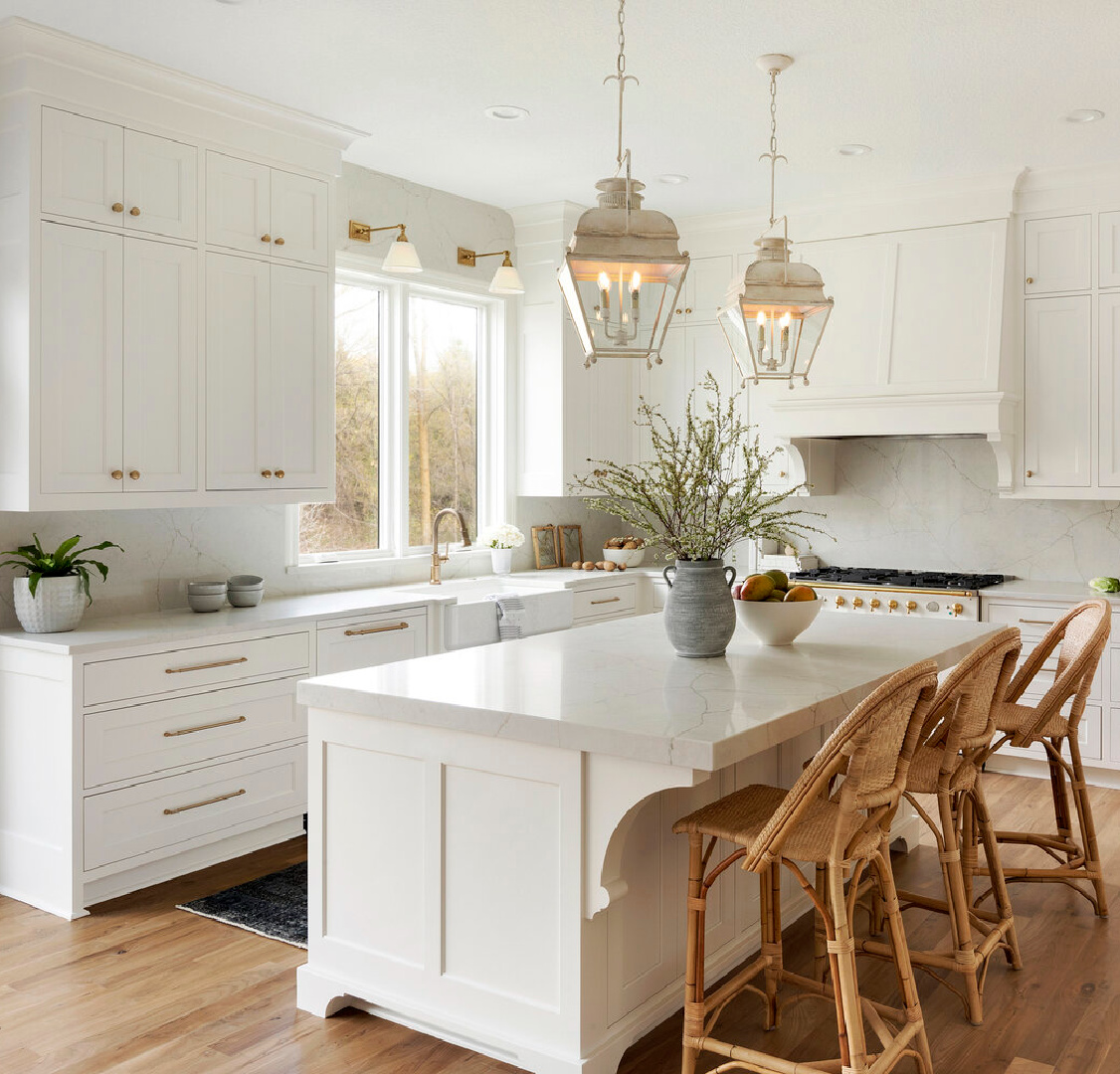 Sherwin Williams Alabaster kitchen cabinets in kitchen with Holborn lanterns over island - Thompson Construction. #swalabaster #sherwinwilliamsalabaster #kitchencabinets