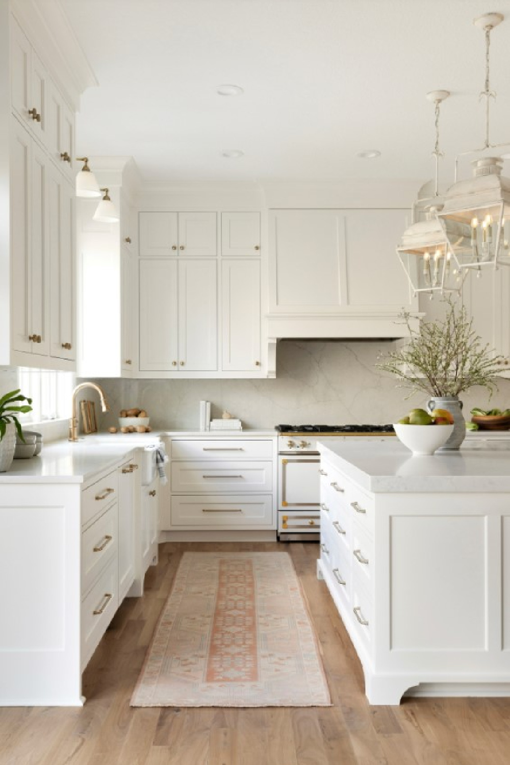 SW Alabaster on kitchen cabinets in a gorgeous timeless kitchen with Holborn lanterns over island - Thompson Construction. #swalabaster #sherwinwilliamsalabaster #kitchencabinets