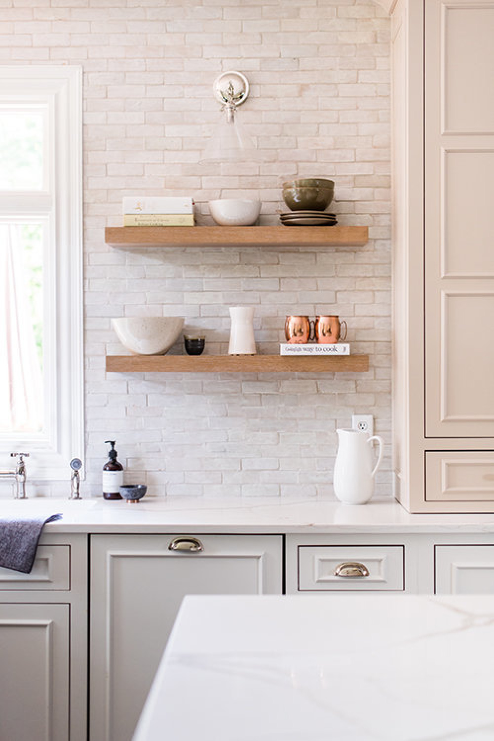 Two tone timeless white kitchen with floating shelves and design by Whittney Parkinson. #floatingshelves #whitekitchens
