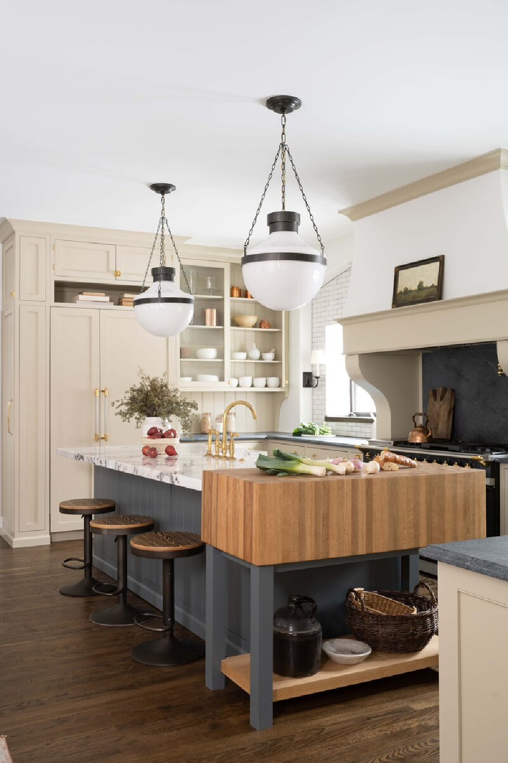 Warm white kitchen with dark painted island and design by Whittney Parkinson. #warmwhitekitchen #whitekitchencabinets