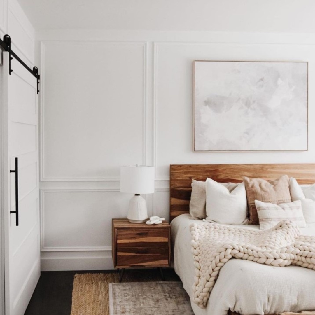 Serene rustic white modern bedroom painted BM Chantilly Lace with barn door and chunky knit throw - @amypeters. #bmchantillylace