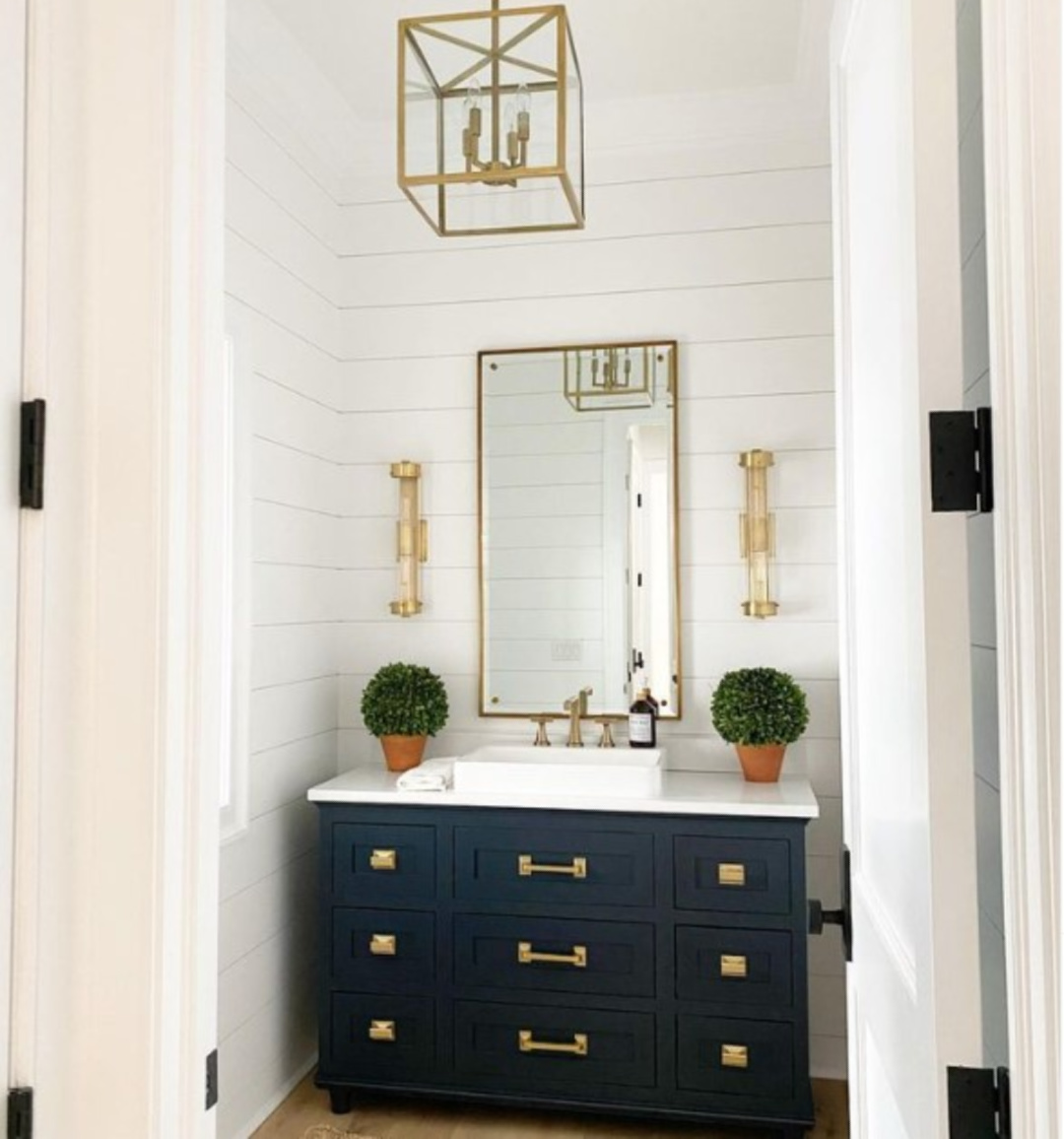 Bathroom with shiplap painted Chantilly Lace and brass hardware - @mlr.interiors. #bmchantillylace