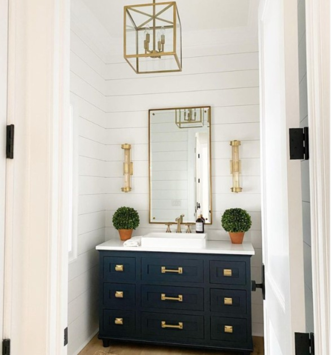 Black bath vanity against shiplap painted Chantilly Lace and brass hardware - @mlr.interiors. 