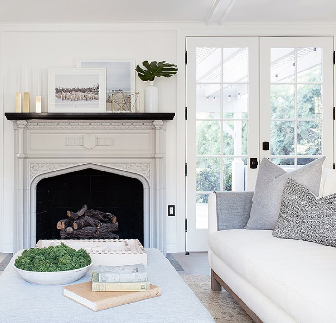 Beautiful vintage fireplace in a chic white California home with Chantilly Lace painted walls in living room - Erin Fetherston.
