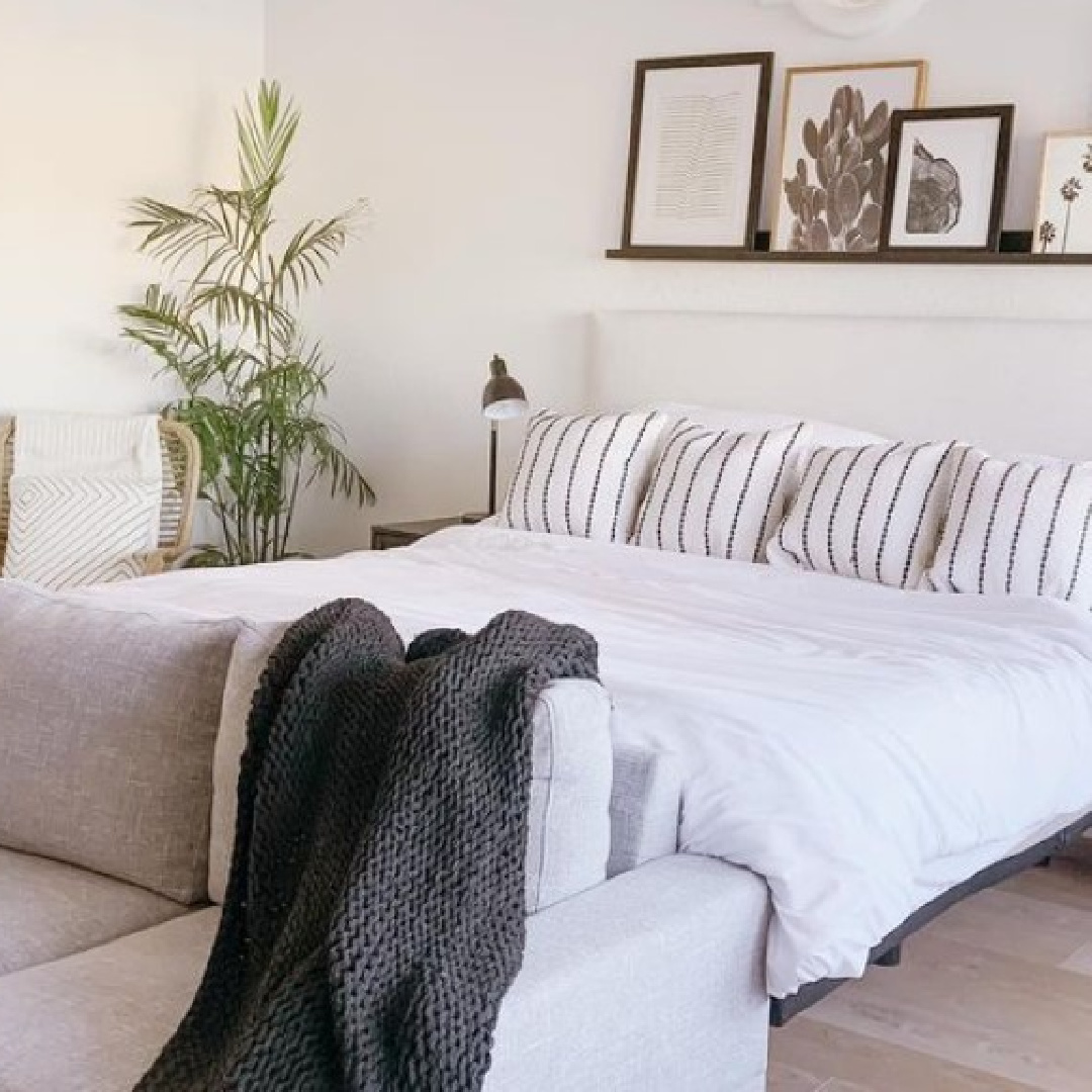 BM Chantilly Lace in neutral bedroom with black accents and floating shelf above bed - @theazbeachhouse