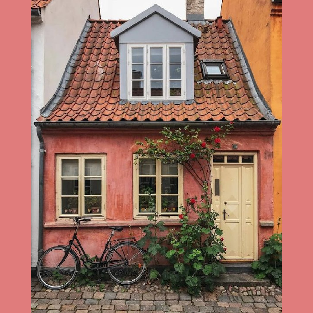 Coral pink tiny cottage in Denmark with charming, storybook charm - @artstation. #tinyhousedesign #cottageexteriors
