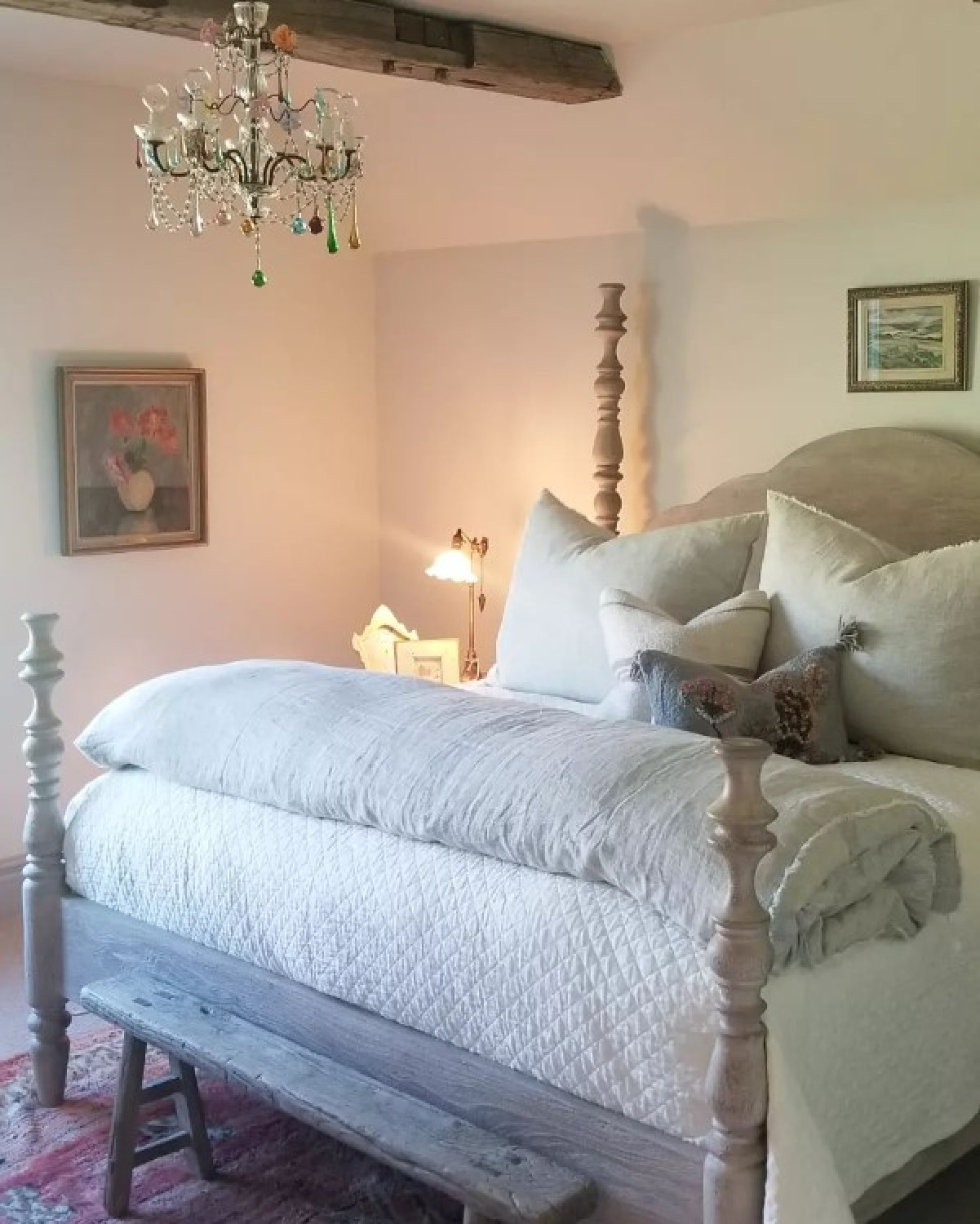 Romantic European country bedroom with poster bed, rustic wood ceilings, vintage chandelier, and pale sumptuous bedding - @beljarhome. #romanticbedrooms #europeancountrystyle