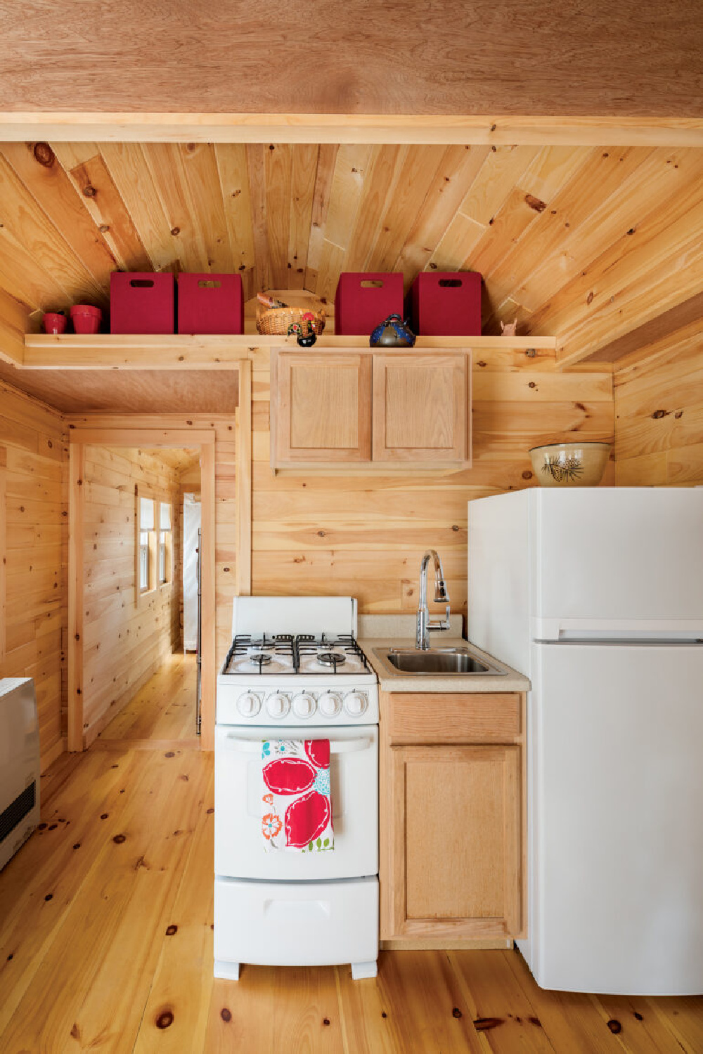 Knotty wood plank walls and ceilings in a tiny cottage in Maine - @downeast. #tinyhouseinteriors #rusticpaneling