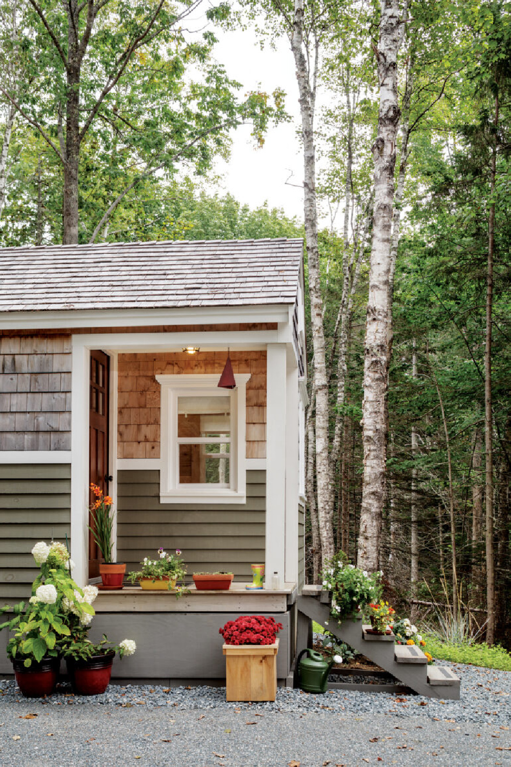 Cedar shake shingles accent a tiny house cottage exterior in Maine - @downeast. #tinyhouseliving #tinyhousearchitecture
