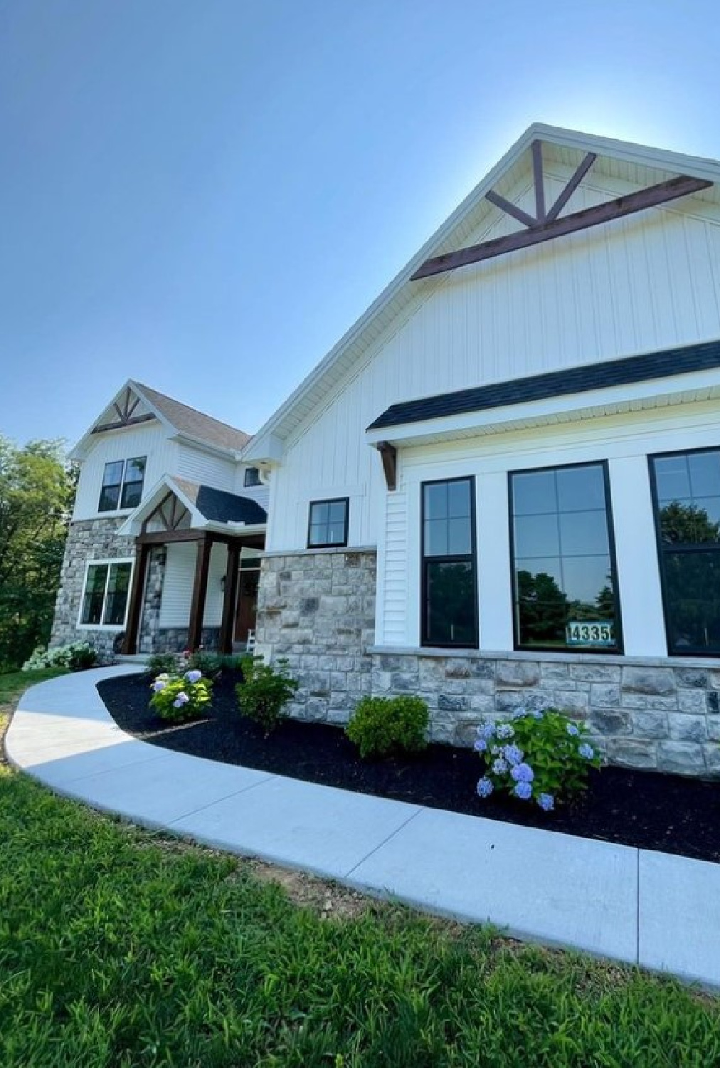 Eider White Sherwin Williams painted modern farmhouse exterior with brick - @aepainters. #eiderwhite