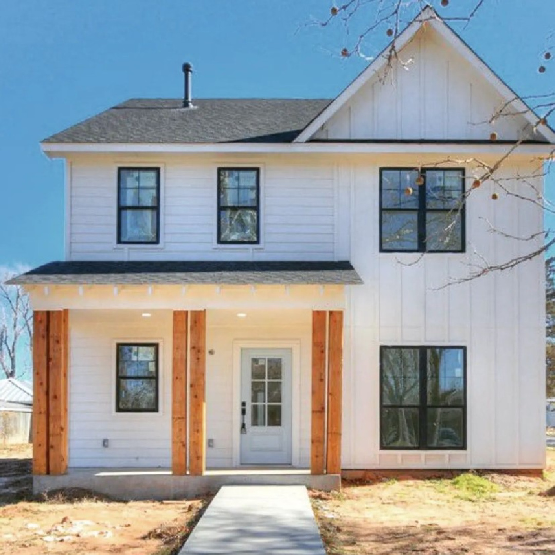 BM Simply White OC-117 with Iron Ore for trim on a white farmhouse - @therowanlayneproject. #bmsimplywhite #whiteexteriors