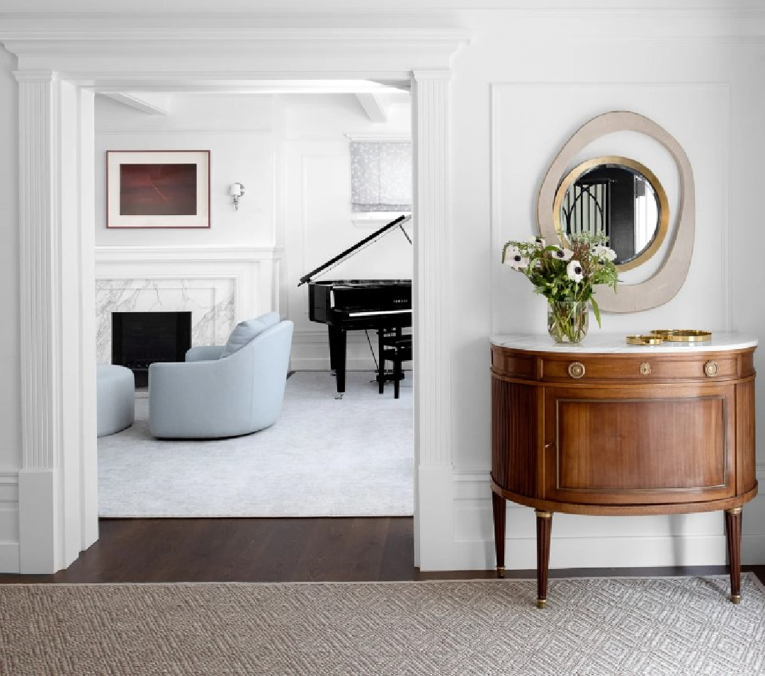 Beautiful entry and peek into living room with light blue chambray chairs - Marea Clark Interiors.