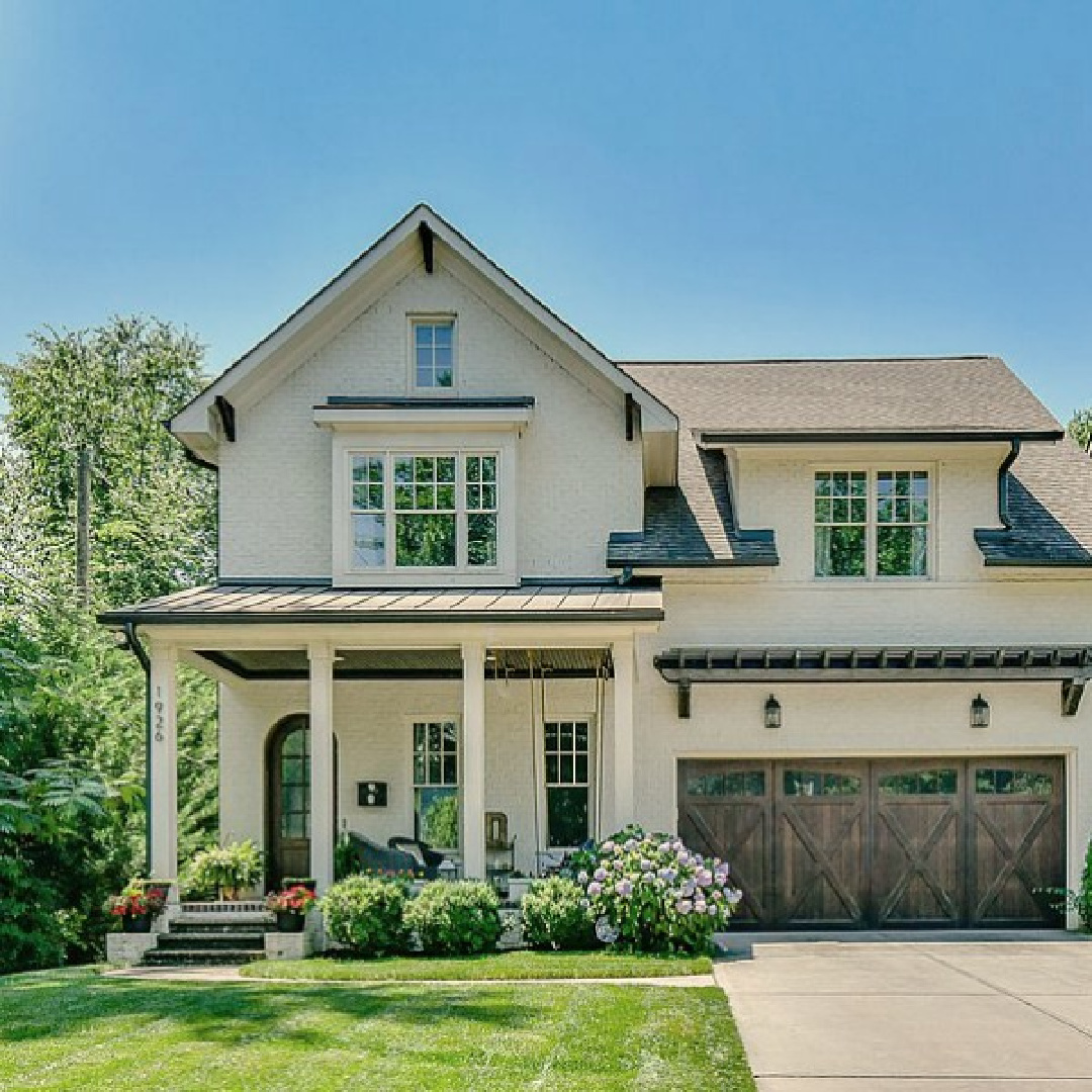 This charming home exterior in Charlotte, NC, boasts curb appeal, traditional design, and inspiring architectural details - Hello Lovely Studio. Try BM Revere Pewter for a comparable exterior color. 