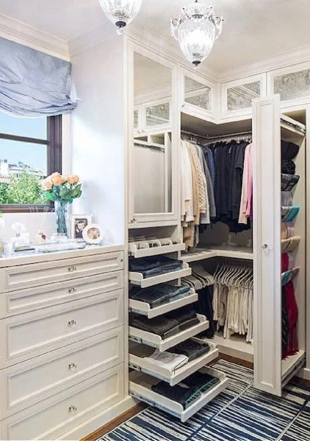 Custom closet with white cabinetry pull outs, mirrored cabinet doors, and built-in dresser - DecorPad. #customclosets