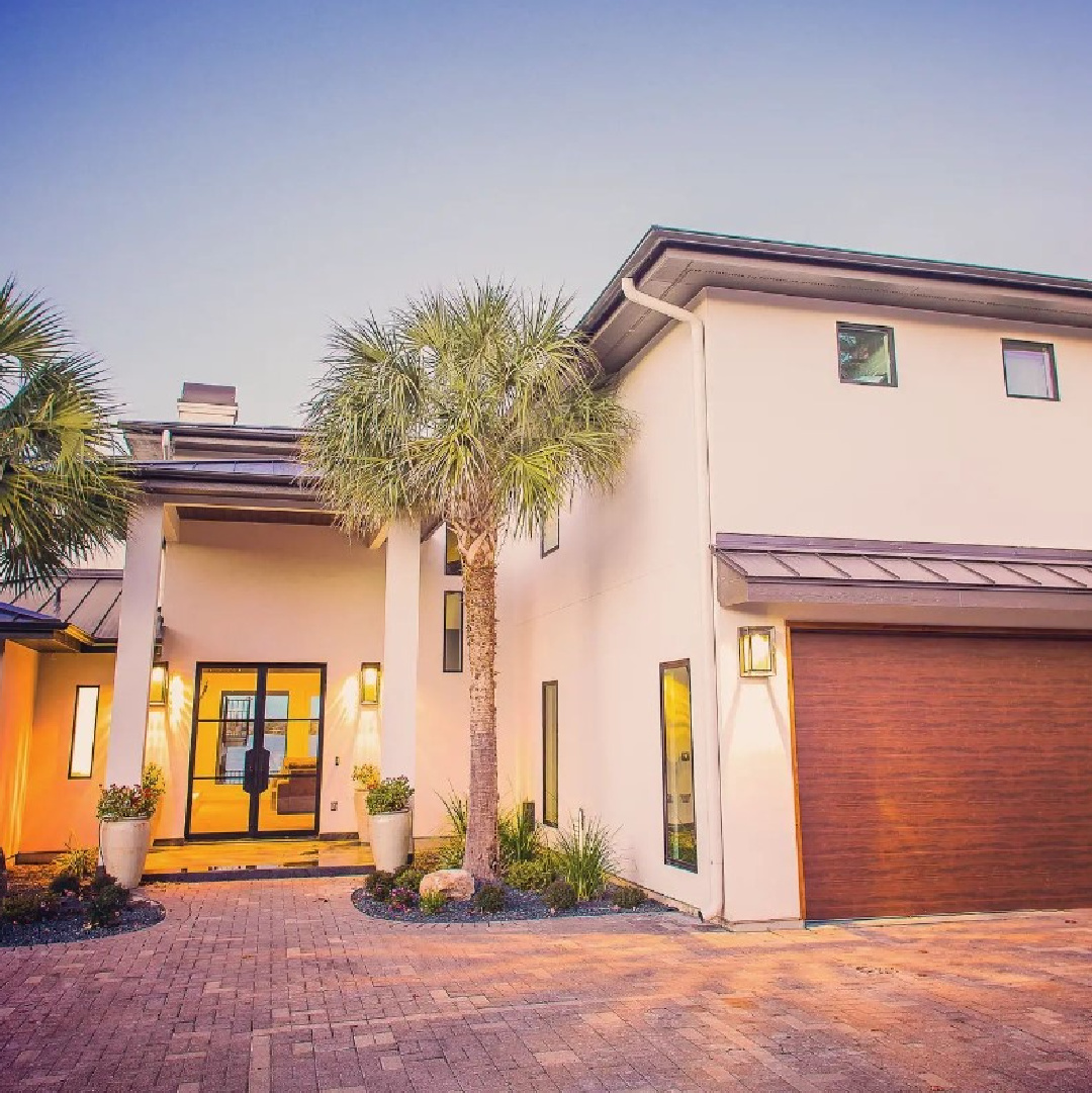 Eider White (Sherwin-Williams) painted exterior on a modern stucco home with wood garage door - @healthierhomesbyjx2. #eiderwhite