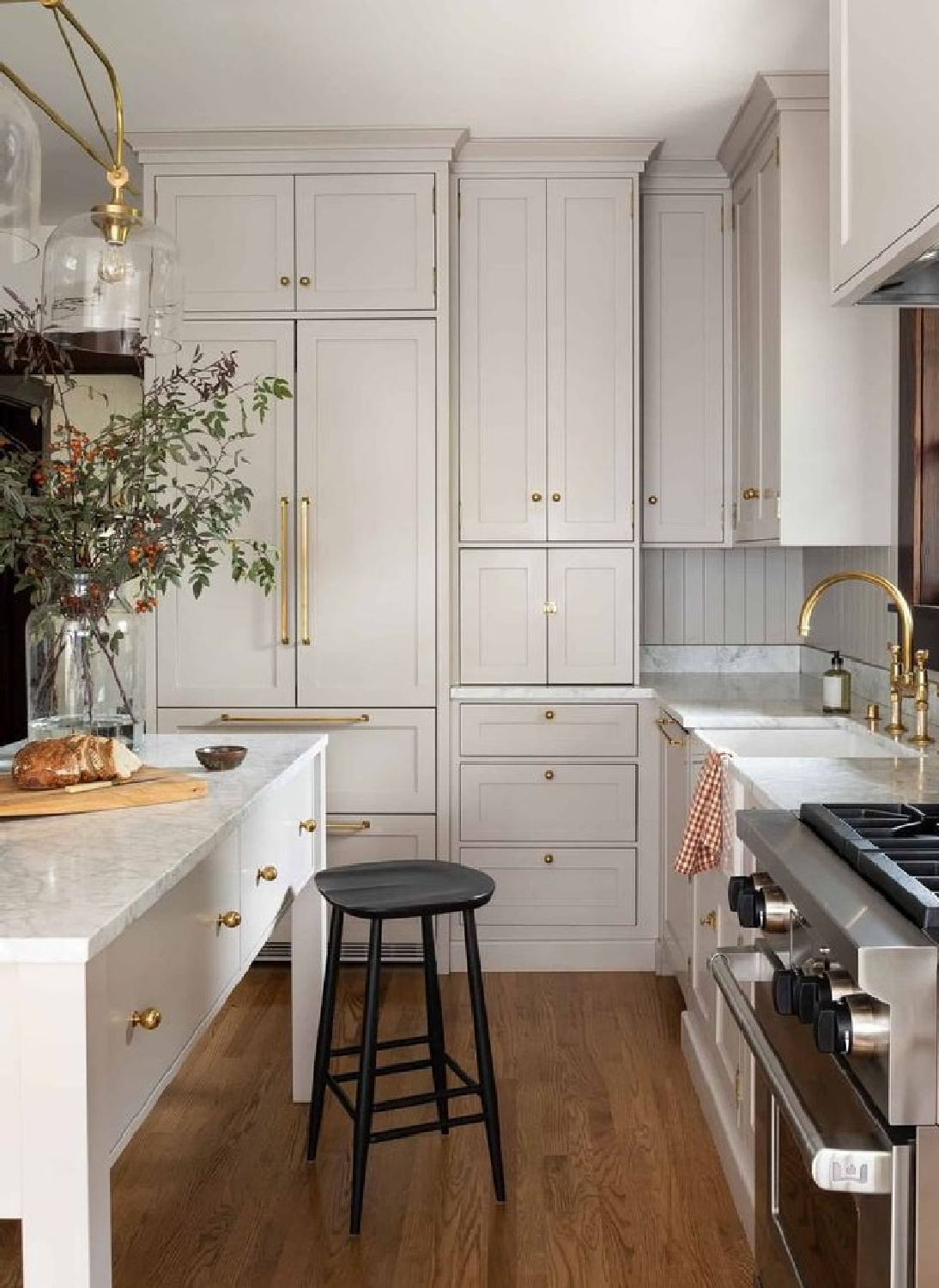 Bespoke kitchen with warm greige kitchen cabinets and brass hardware - @heidicaillierdesign. #greiegekitchens #serenekitchen #beigekitchencabinets