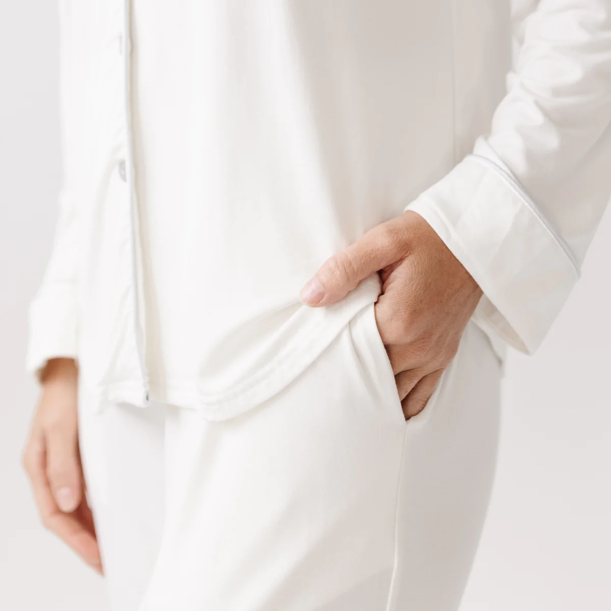 Stretch knit pajamas in white with pockets in pants, Cozy Earth.