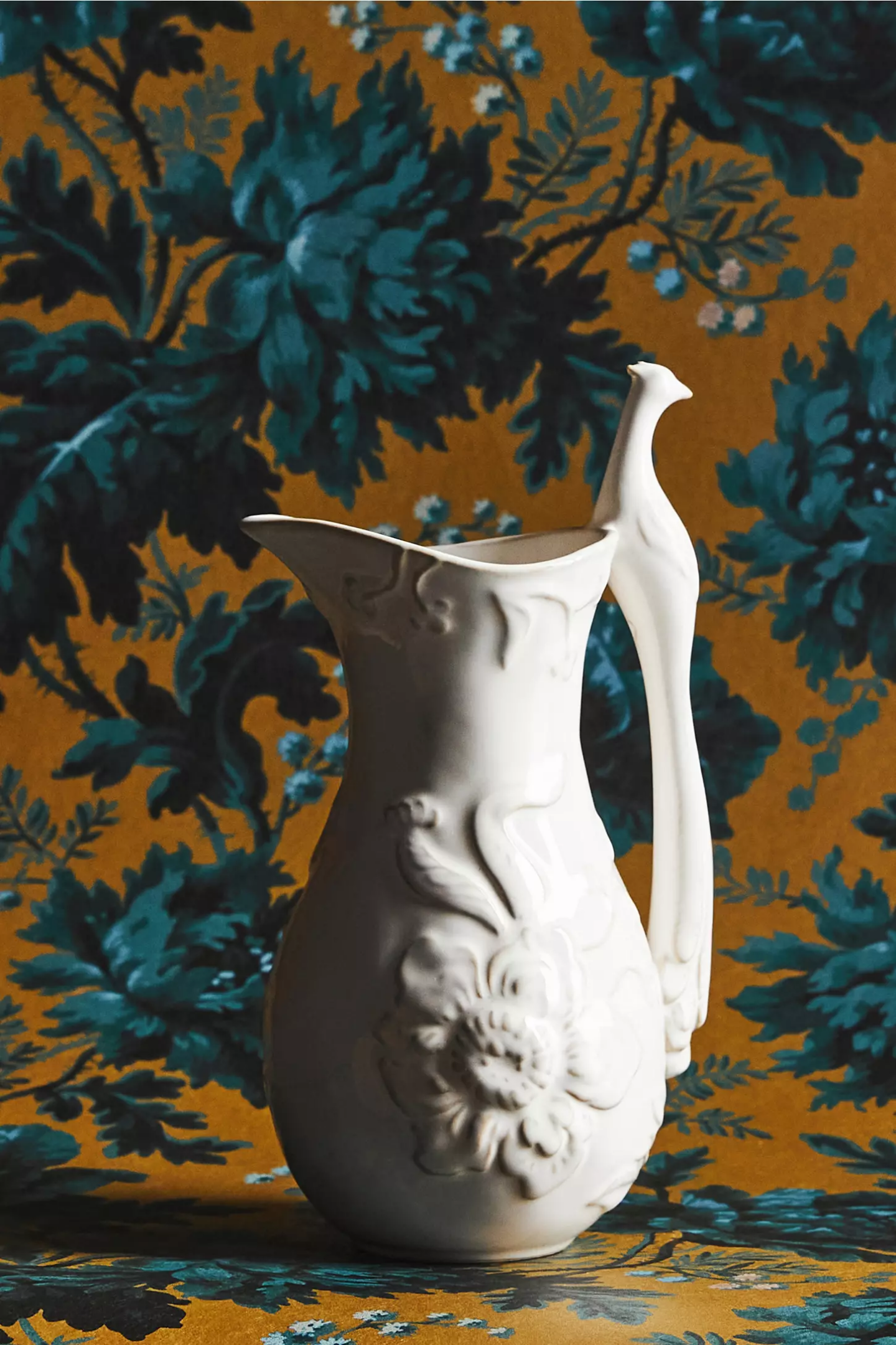 House of Hackney Plume Pitcher against teal floral wallcovering, Anthropologie