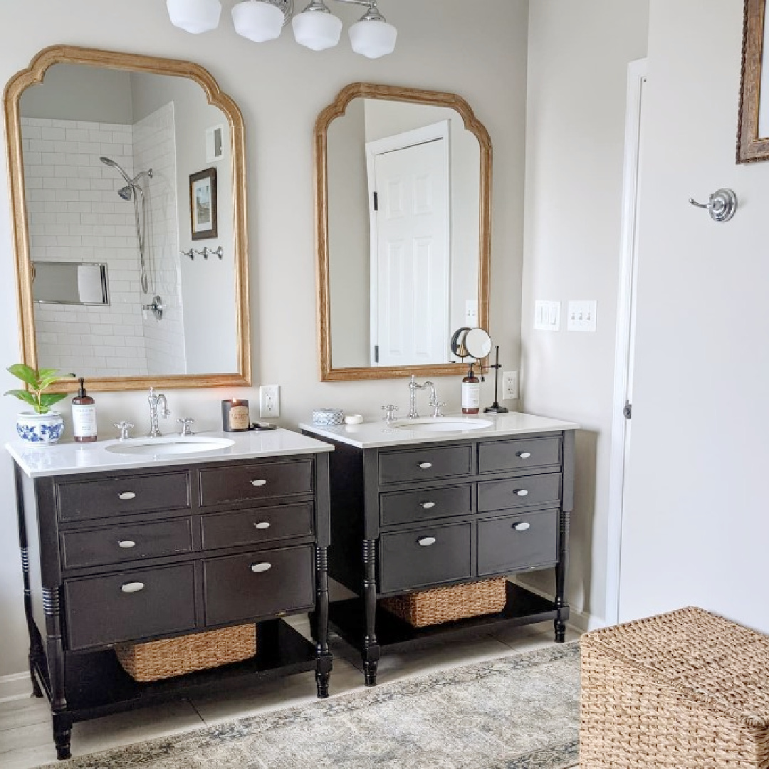 SW Agreeable Gray on walls in classic bathroom with dark vanities and gold mirrors - @homeonportsmouth
