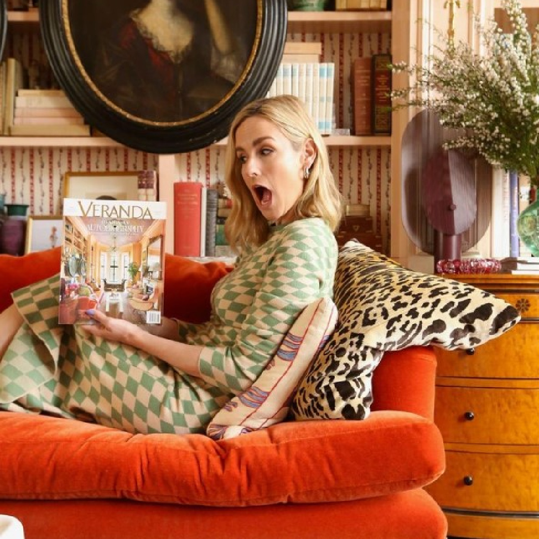 Summer Thornton on orange velvet sofa holding Veranda magazine which features her work on cover. #summerthornton #chicagodesigners