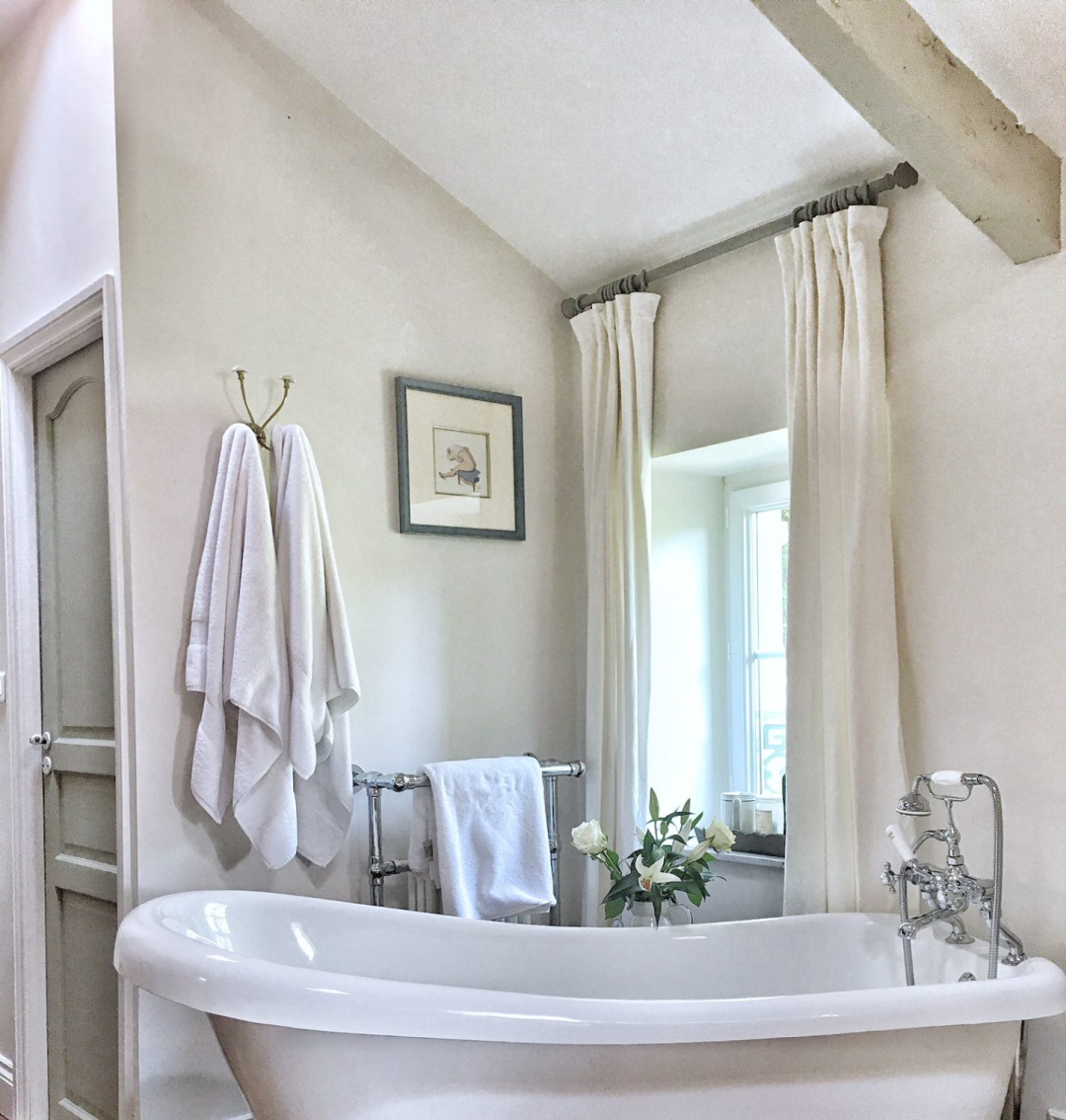 Vivi et Margot French farmhouse bathroom with Strong White Farrow & Ball paint color on walls, clawfoot tub, and French Gray on door. #strongwhite #farrowandballstrongwhite