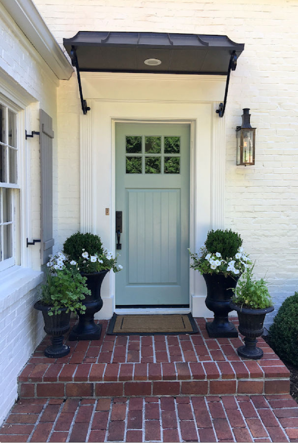 Benjamin Moore Wythe Blue front door on a beautiful white (SW Alabaster) brick home - Ladisic Fine Homes. #benjaminmoorewytheblue #paintcolors #frontdoor