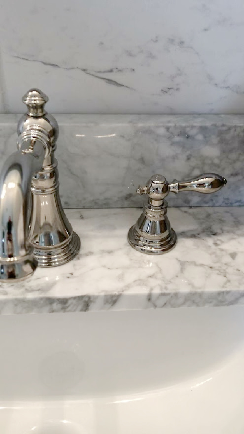 Detail of Edwardian bath faucet and carrera marble vanity top in bath at the Georgian - Hello Lovely Studio.