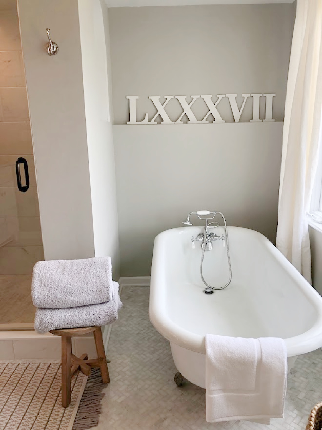 SW Repose Gray walls in modern French renovated bath with vintage clawfoot tub - Hello Lovely Studio. #swreposegray