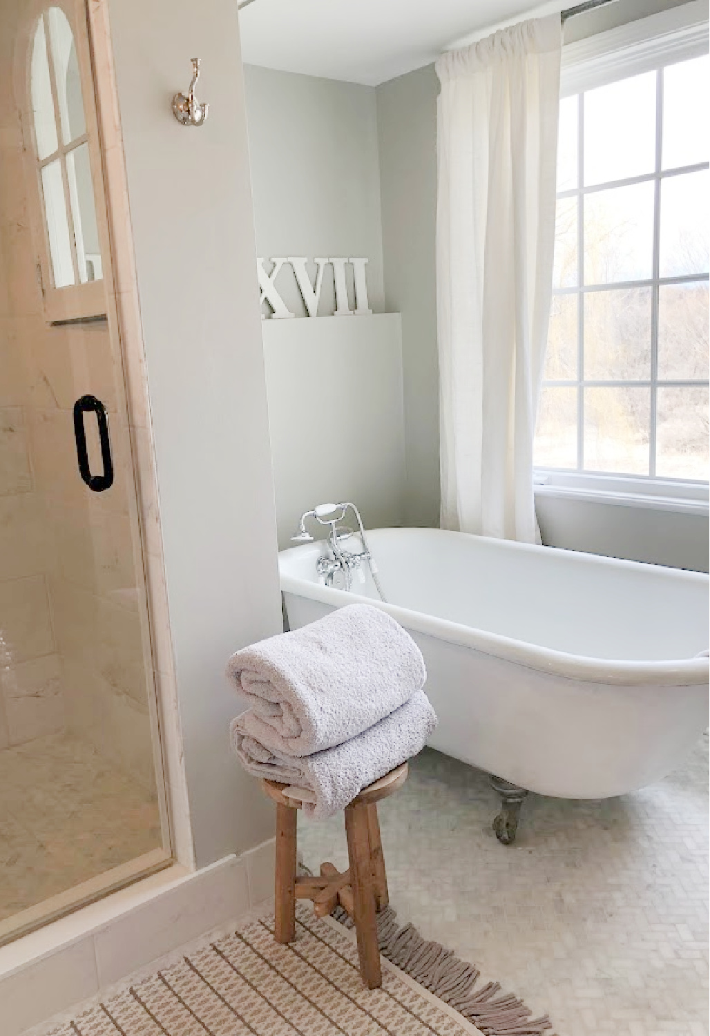 SW Repose Gray walls in modern French renovated bath with vintage clawfoot tub - Hello Lovely Studio. #swreposegray