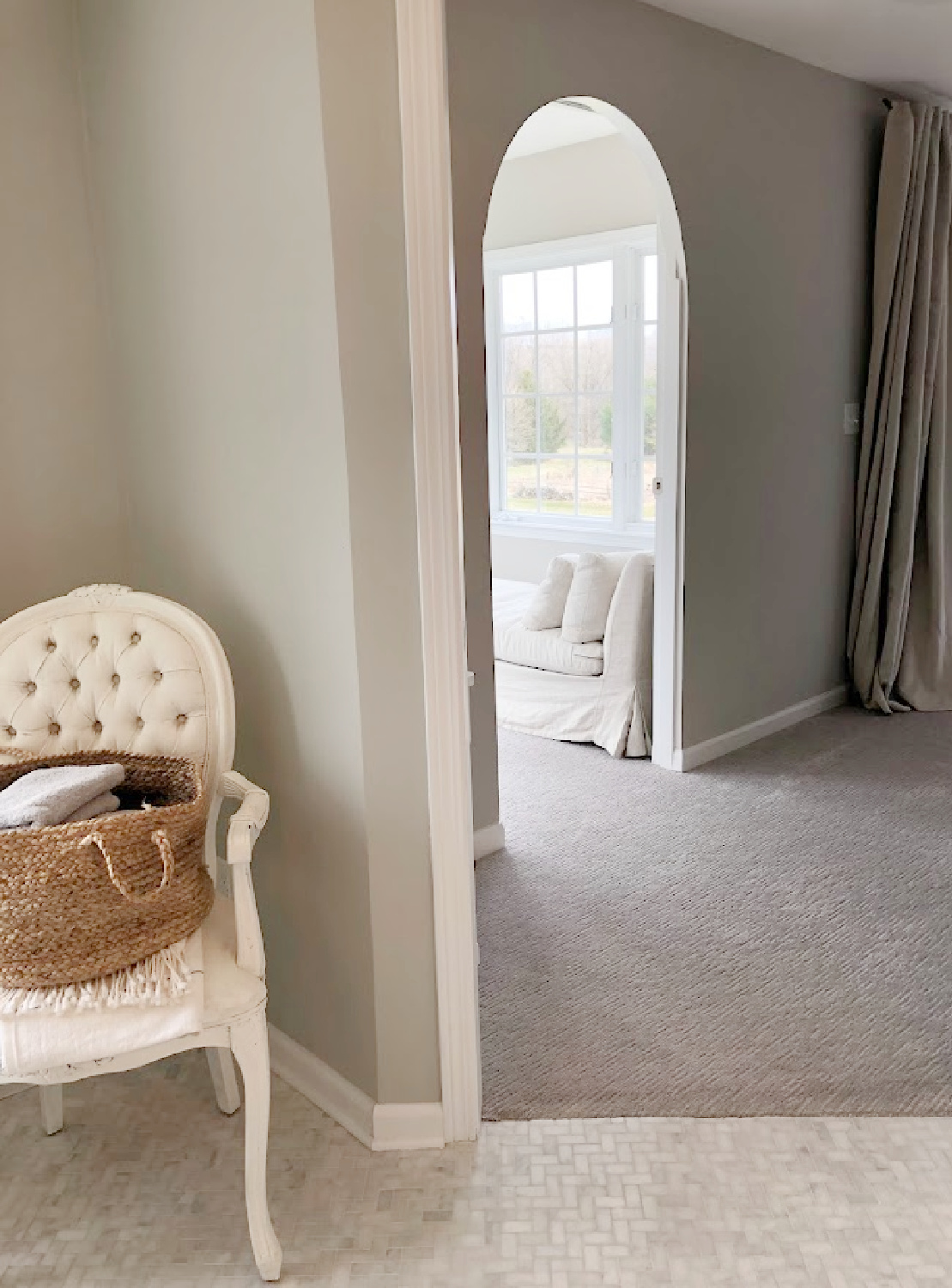 View from bath through bedroom to turret sitting room in coastal bedroom remodel (SW Agreeable Gray on walls) at the Georgian - Hello Lovely Studio. #agreeablegray #swagreeablegray