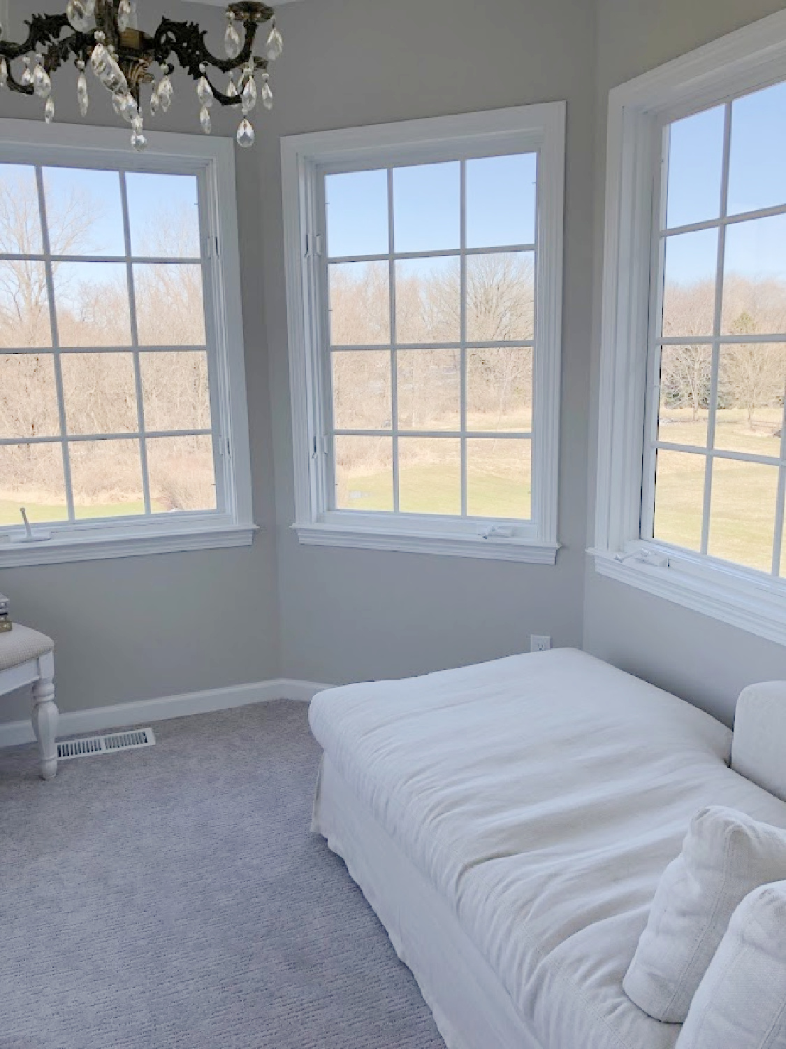 Belgian linen chaise in turret sitting room in coastal bedroom remodel (SW Agreeable Gray on walls) at the Georgian - Hello Lovely Studio. #agreeablegray #swagreeablegray