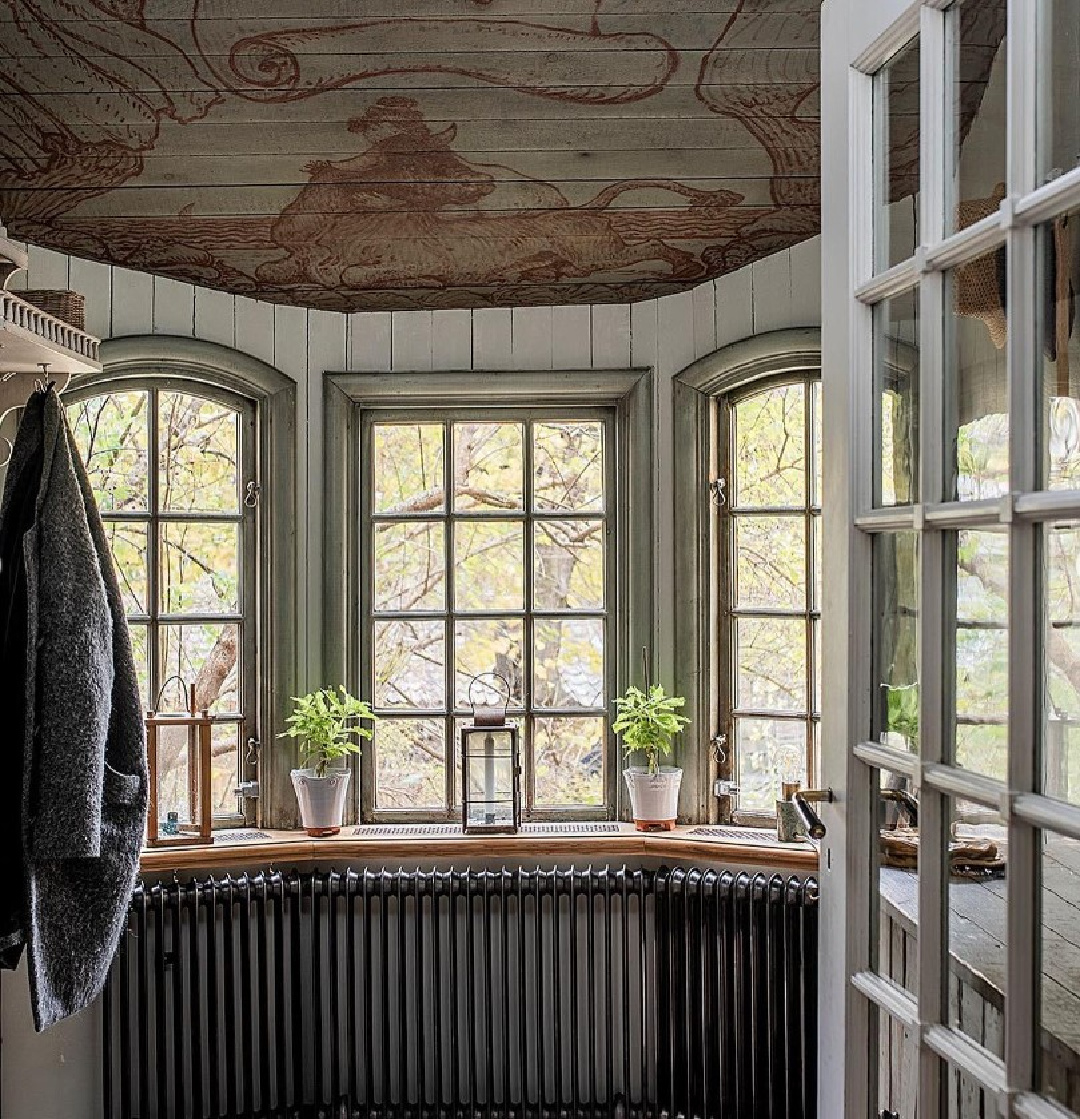 Bay window, handpainted ceiling, and elegant rustic design in a Stockholm apartment - @historiskehem. #stockholmapartment