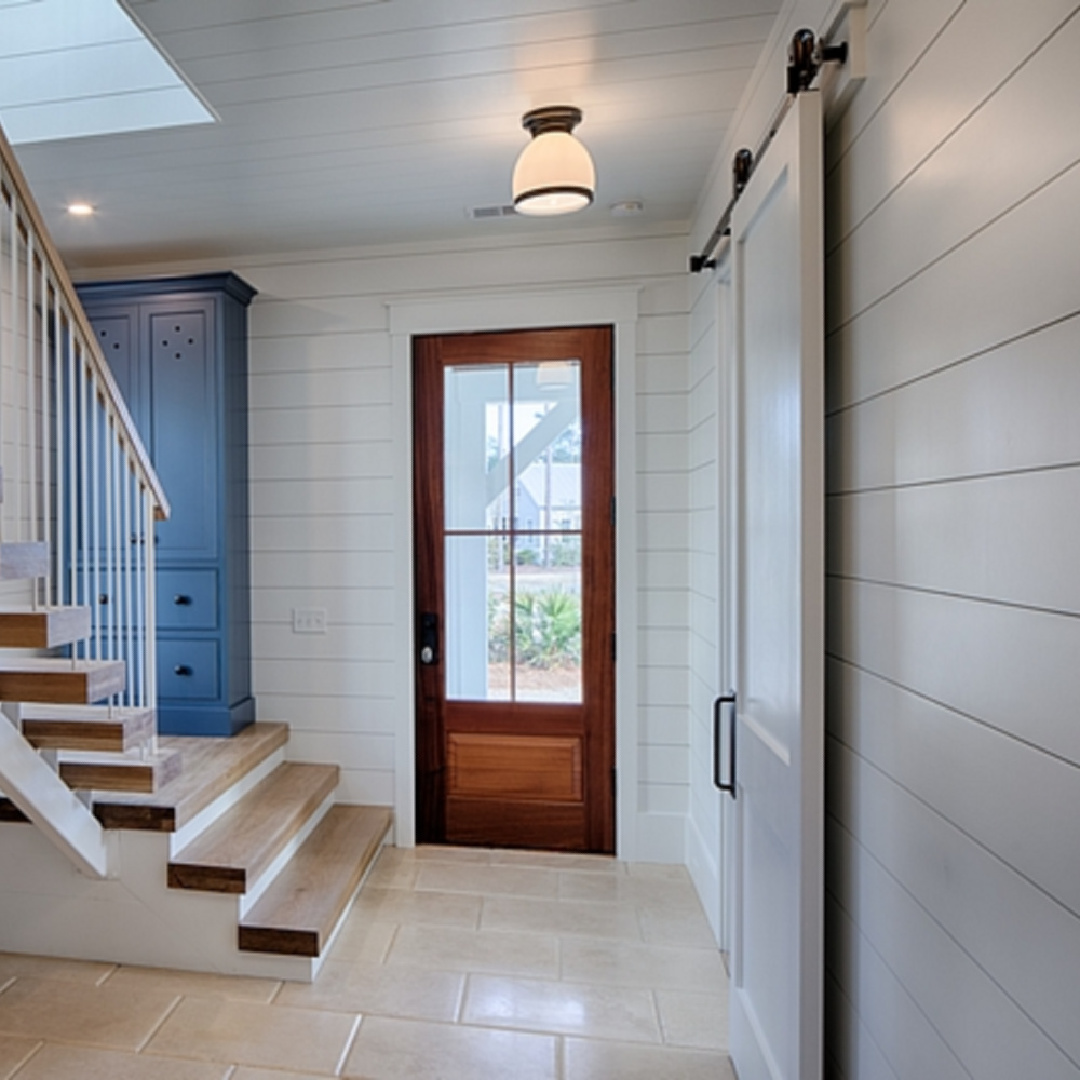 Shiplap walls (painted BM White) in a gorgeous coastal cottage entry with tall blue custom cabinet - come get the details and design resources! #coastalcottage #modernfarmhouse #interiordesign