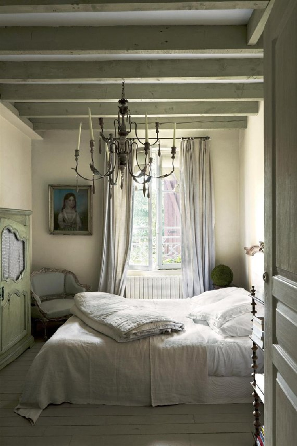 Ball Green (Farrow & Ball) in a tranquil Old World style European bedroom with wooden ceiling beams. #ballgreen #greenpaintcolors