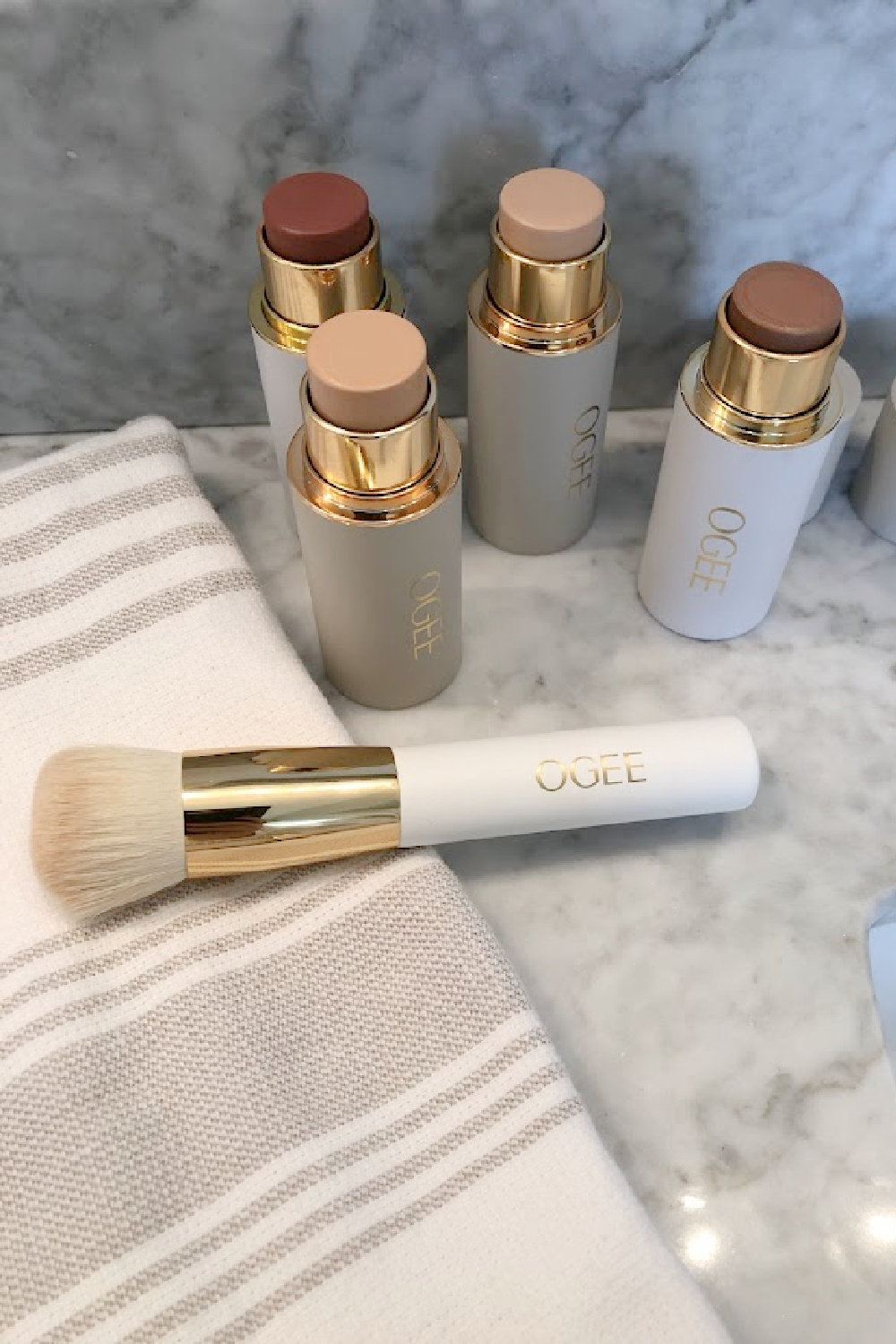 OGEE's organic complexion sticks, face sticks, and blender brush on my vanity - Hello Lovely Studio. #organicmakeup #cleanmakeup #ogee