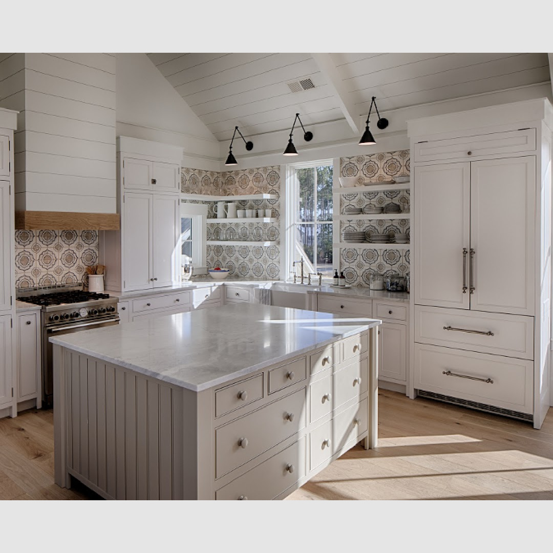 White coastal kitchen with modern farmhouse and Shaker designer elements. Lisa Furey created a welcoming home with shiplap, nods to coastal design, and blue accents. #coastalkitchen 