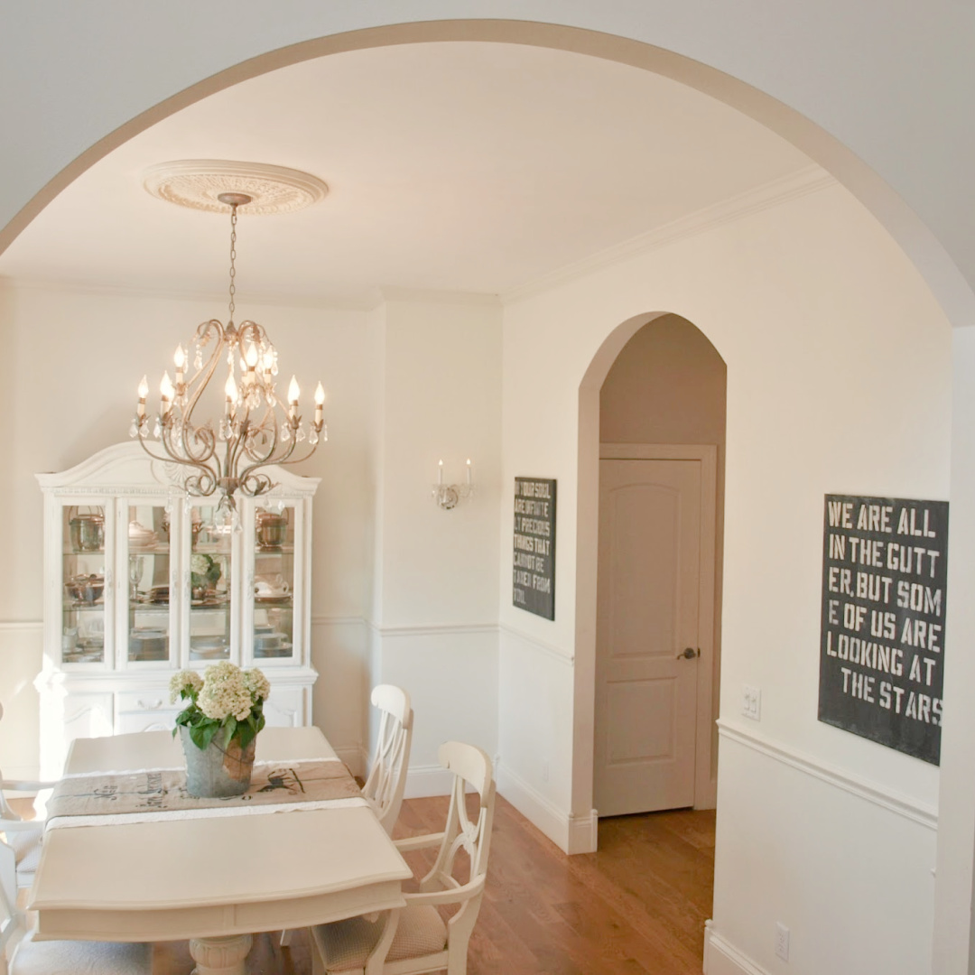 BM White Sand in our French country dining room with antique grainsack runner and galvanized bucket of hydrangea - Hello Lovely Studio. #hellolovely #bmwhitesand #frenchcountrywhites