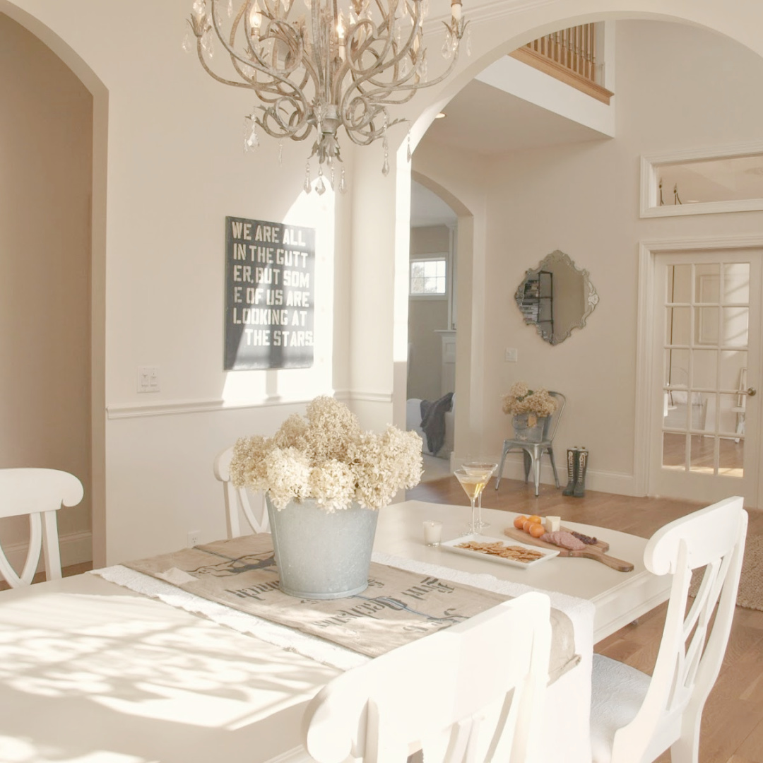 BM White Sand in our French country dining room with antique grainsack runner and galvanized bucket of hydrangea - Hello Lovely Studio. #hellolovely #bmwhitesand #frenchcountrywhites