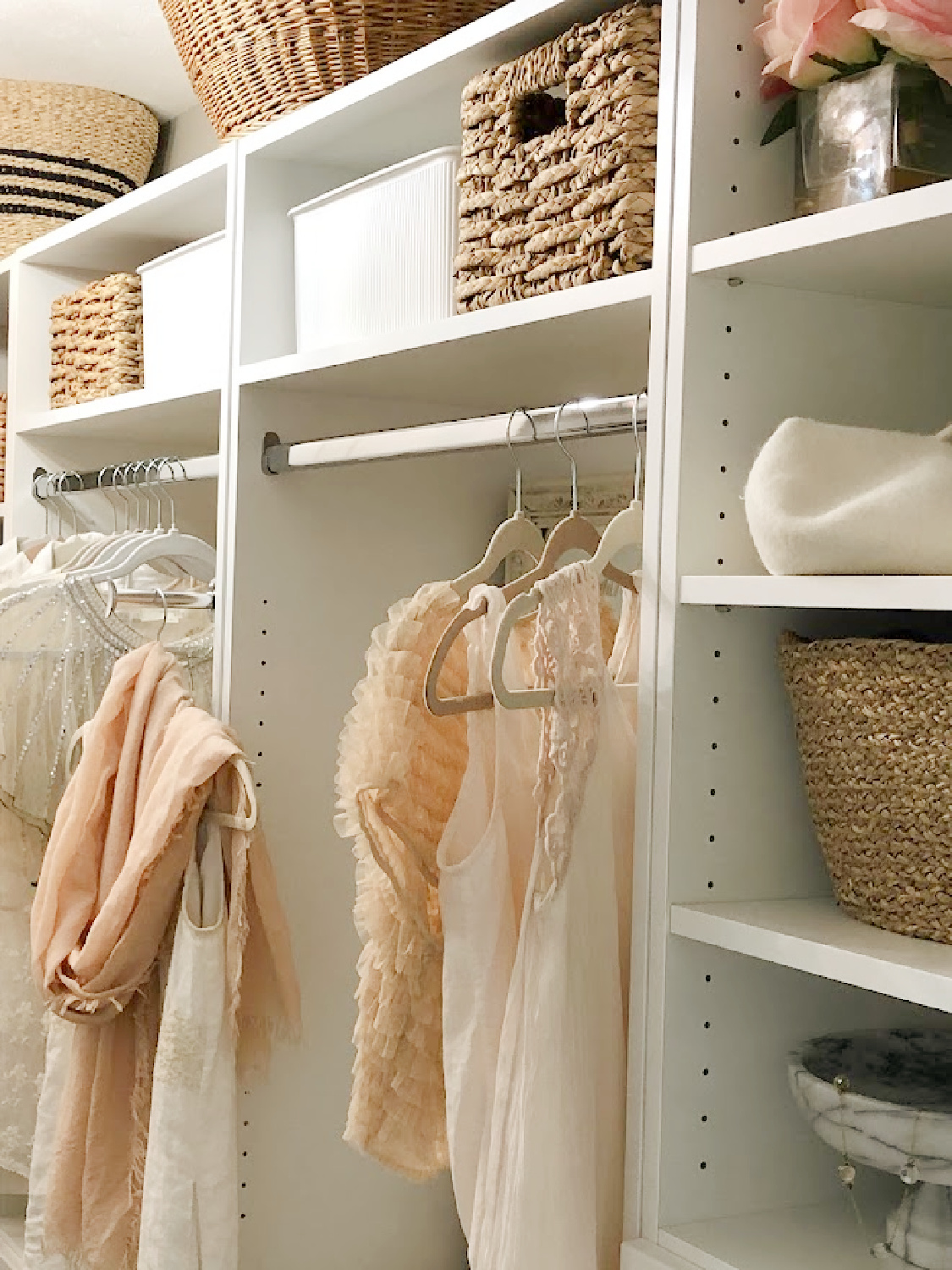 Hello Lovely's before & after walk-in closet shares a custom closet DIY with white Shaker style towers and drawers from Modular Closets. This his and hers closet makes the most of every inch. #closetupgrades #diycloset #customclosetideas #closetmakeover #closetmodules #diyclosetmakeover