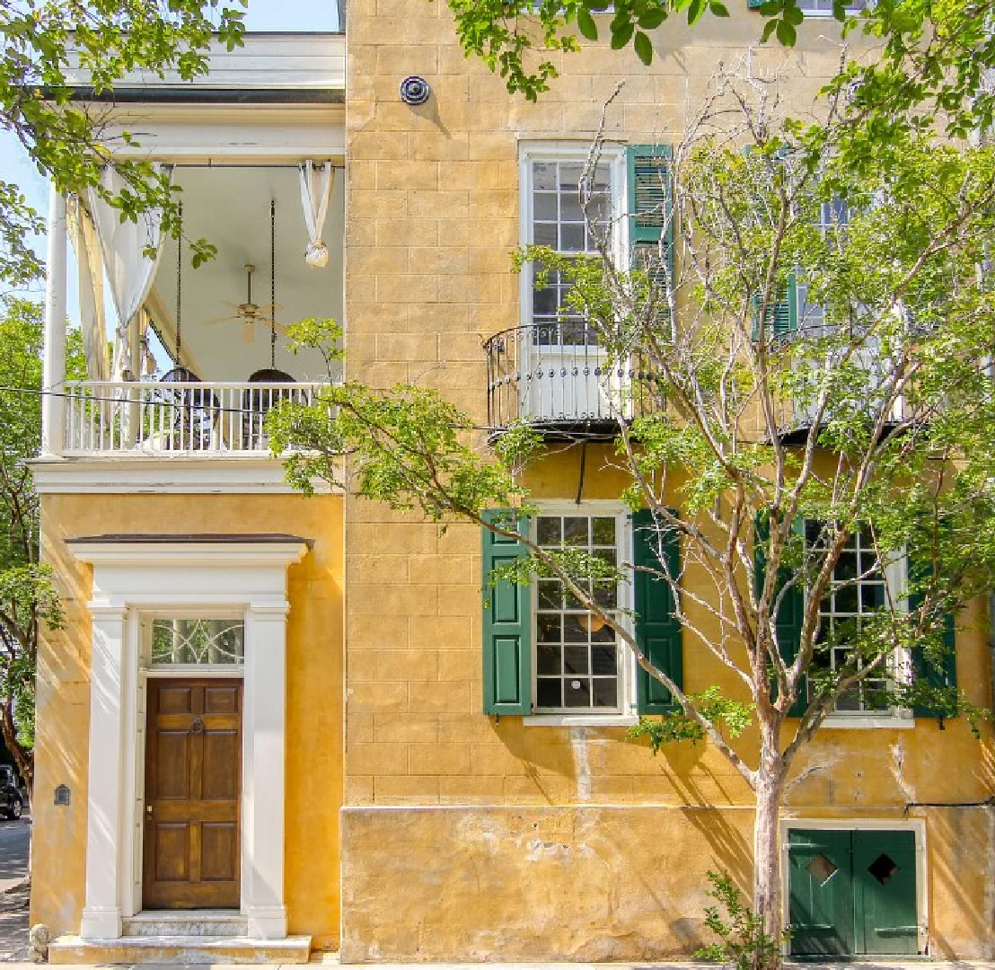 Gorgeous yellow home exterior with green shutters on a 1777 built home in Charleston, SC (4 Legare St.). #charlestonhomes #yellowhouses